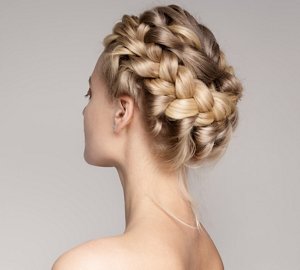 Blonde woman wearing her hair in a plaited halo braid